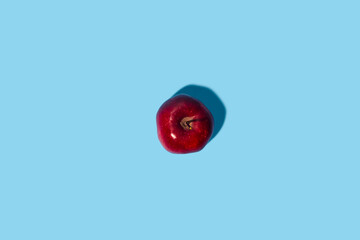 Wall Mural - Fresh red apple on a blue background. Top view, flat lay.