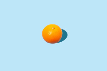 Wall Mural - Fresh orange on a blue background. Top view, flat lay.