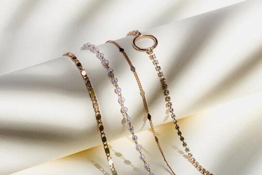 gold necklaces on roll shadow jewelry product photography sunshine warmth tropical sun flatlay