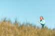 © eshana_blue - Young active woman jogging in the field in the countryside