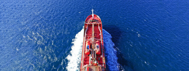 Aerial drone ultra wide photo of oil - petrochemical tanker cruising deep blue open ocean sea