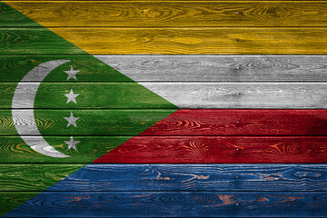 Wall Mural - The national flag of Comoros. is painted on a camp of even boards nailed with a nail. The symbol of the country.