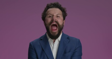 Poster - crazy happy man in suit standing with folded arms, screaming, having fun and grimacing, making crazy faces, being idiot on purple background