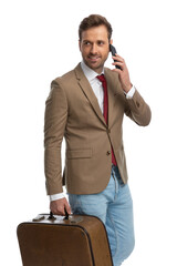 Wall Mural - handsome businessman talking on the phone, looking away