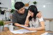 © Pormezz - Stressed Asian couple reading notice mail from the bank about unpaid house mortgage