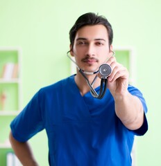 Wall Mural - Young doctor working in the hospital