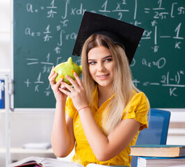 Wall Mural - The young female student in front of the chalkboard