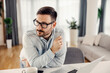 © dusanpetkovic1 - A man with eyeglasses thinking while leaning on kitchen counter at his cozy home.