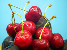 Many Sweet Fresh Summer Dark Red Cherries And Plums Berries Background