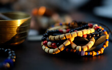 Tibetan Beads And Bracelet Close Up On Dark Abstract Backgound, Meditation And Relaxing Concept