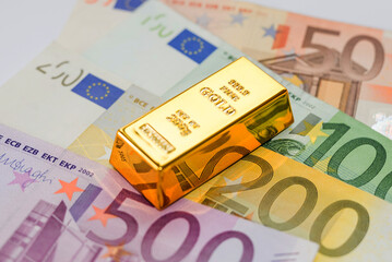 gold bar on the background of euro banknotes