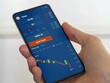 © maurice norbert - Stock exchange market chart,  exchange-Traded Fund data on smartphone. Business analysis of gold