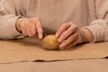 Wall Mural - heart shaped potato stamp on craft paper. The process of decorating a gift for Valentine's Day. Getting ready for the celebration on February 14th.