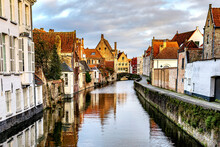 View Of Historical City Of Bruges At West Flanders Province In Belgium. Inner Canals Surrounded By Old Historical Buildings. 