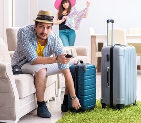 Wall Mural - Young family packing for vacation travel