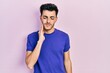 © Krakenimages.com - Young hispanic man wearing casual t shirt touching mouth with hand with painful expression because of toothache or dental illness on teeth. dentist