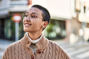 Beautiful hispanic woman with short hair smiling happy outdoors