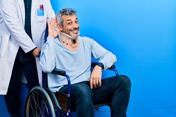 Poster - Handsome middle age man with grey hair on wheelchair wearing cervical collar smiling with hand over ear listening an hearing to rumor or gossip. deafness concept.