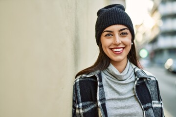 Wall Mural - Young hispanic woman smiling happy standing at the city.