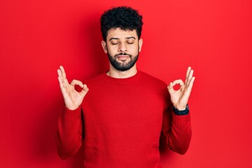 Poster - Young arab man with beard wearing casual red sweater relax and smiling with eyes closed doing meditation gesture with fingers. yoga concept.