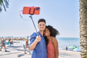 Canvas Print - Man and woman couple hugging each other make selfie by the smartphone at seaside