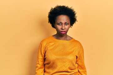 Poster - Young african american woman wearing casual clothes skeptic and nervous, frowning upset because of problem. negative person.