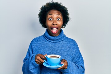 Poster - Young african american woman drinking a cup of coffee celebrating crazy and amazed for success with open eyes screaming excited.