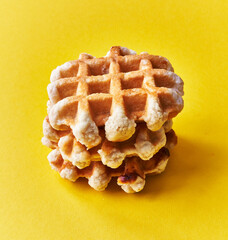 Wall Mural -  Bunch of delicious waffles over yellow background