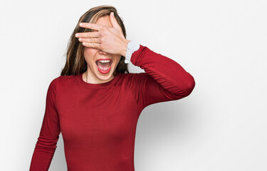 Wall Mural - Young blonde woman wearing casual clothes smiling and laughing with hand on face covering eyes for surprise. blind concept.