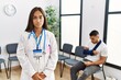 © Krakenimages.com - Young asian doctor woman at waiting room with a man with a broken arm relaxed with serious expression on face. simple and natural looking at the camera.