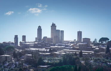 Wall Mural - San Gimignano snowy town, towers skyline and vineyards. Tuscany, Italy