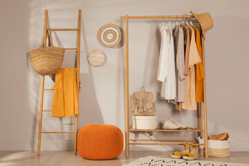 Canvas Print - Modern dressing room interior with stylish clothes, shoes and orange pouf