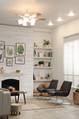 Wall Mural - Stylish living room interior with comfortable chairs and decorative fireplace