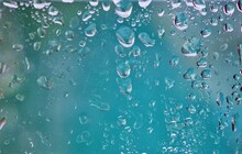Water Droplets On Glass Blue Background Bright Abstract