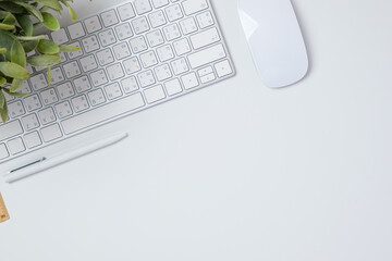 top view working desk with keyboard mouse and notebook on white table backgorund