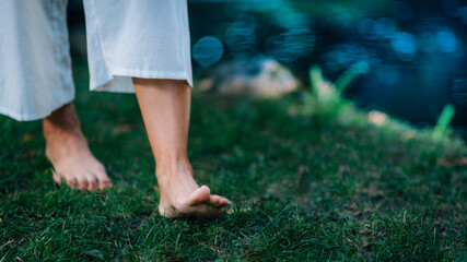 Yoga Woman Walking barefoot, focus on feet.