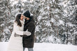 © Bostan Natalia - Happy couple of man and woman hugging on a snowy winter day on trees covered in snow background.