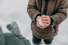 Closeup Of A Boy Making A Snowball With Bare Hands.