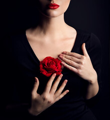 Wall Mural - Woman with Rose Flower and Red Lips Make up over Black. Elegant Lady Fantasy Fine Art Close up Portrait. Beauty Model Body and Hands Cosmetic Care