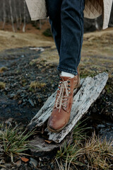 Wall Mural - brown autumn shoes on a wooden board on the nature stream