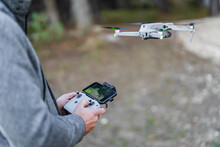 Pilot Drone Flying Through Radio Controlled Handset At Park