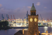 Germany, Hamburg, Saint Pauli Piers Clock Tower With Docked Cruise Ship In Background