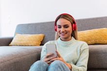 Woman Listening Music On Headphones Sitting At Home