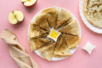 Wall Mural - Russian pancakes with butter and sour cream on pink background, top view