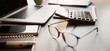 © kite_rin - Accountant workplace, calculator, laptop computer and glasses at office desk panoramic banner, finance, business and accounting concept