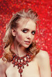 © Miramiska - Luxurious woman on red wearing stunning jewelry. Beautiful woman on red background. Model in expensive rich necklace with precious stones.  Diamonds