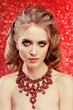 © Miramiska - Luxurious woman on red wearing stunning jewelry. Beautiful woman on red background. Model in expensive rich necklace with precious stones.  Diamonds