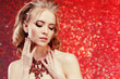 © Miramiska - Luxurious woman on red wearing stunning jewelry. Beautiful woman on red background. Model in expensive rich necklace with precious stones.  Diamonds