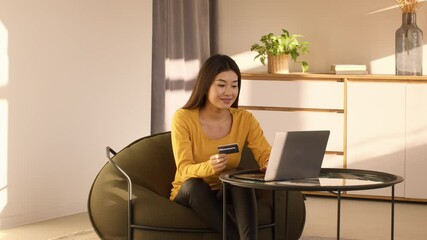 Wall Mural - Japanese Lady Shopping Online Using Laptop And Card At Home