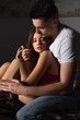© LIGHTFIELD STUDIOS - young man embracing sexy woman sitting in dark bedroom with closed eyes.